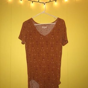 This is a long, light, floral t-shirt.